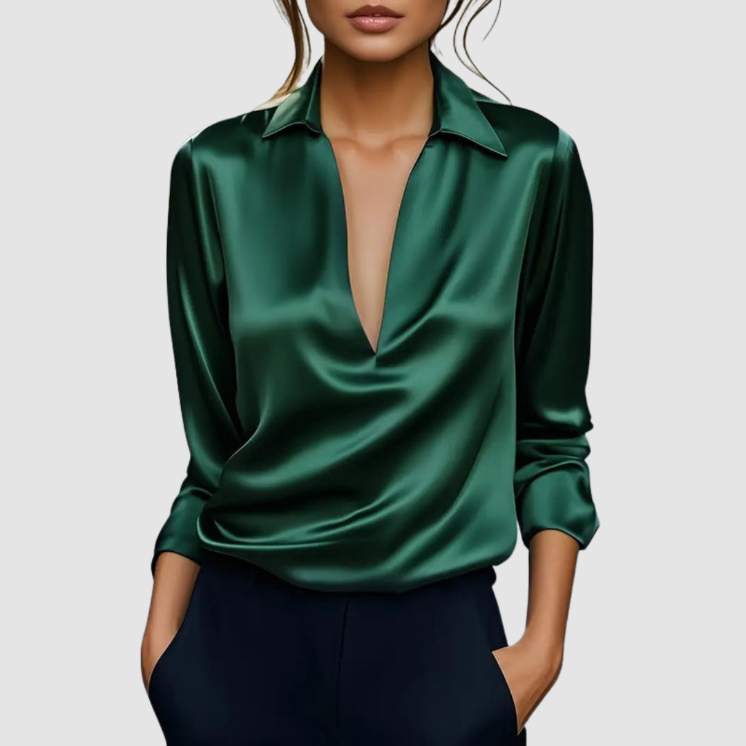 Elegant dark green satin blouse with deep V-neck, worn in a studio setting.