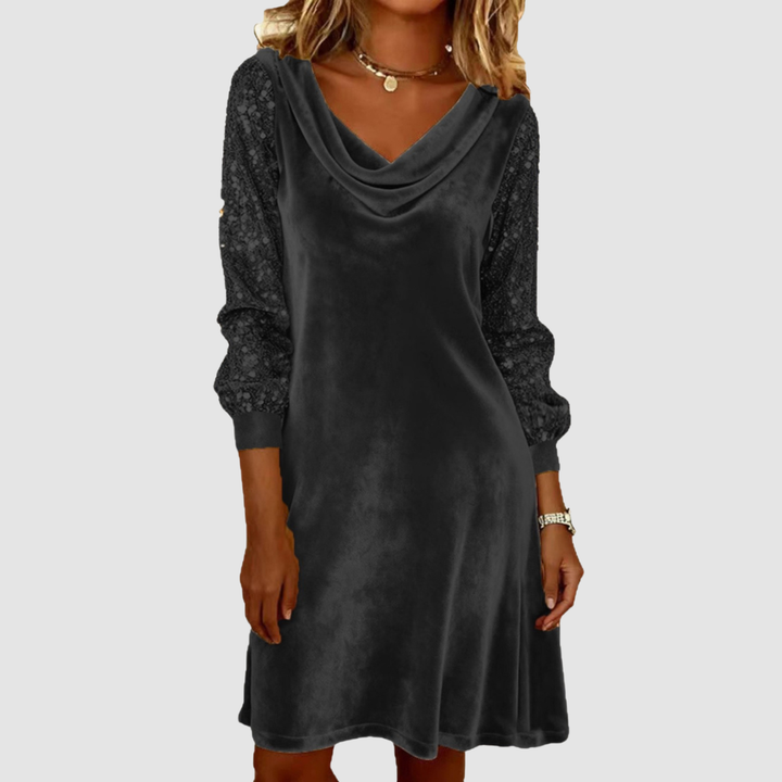 Classic black midi dress with decorative sleeves and draped neckline in a studio background.