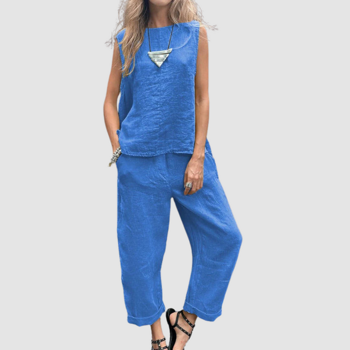 Bright blue two-piece summer set with sleeveless top and loose pants, worn by model, gray background.