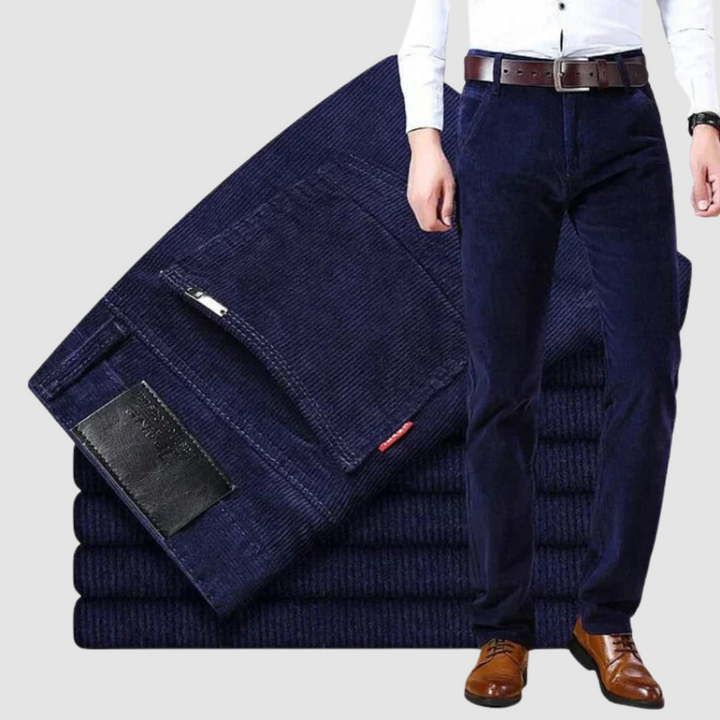 Navy blue corduroy trousers in a studio environment, emphasizing depth of color and soft texture.