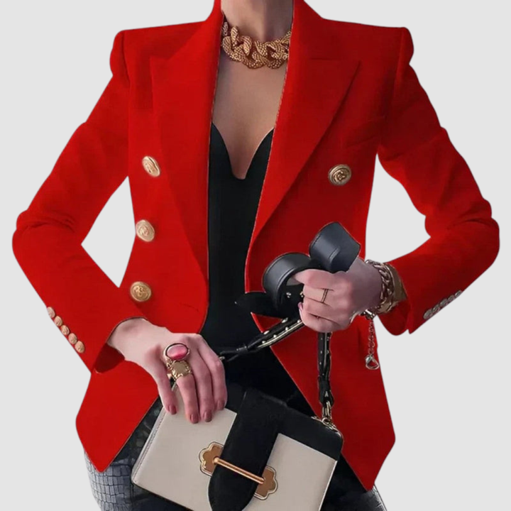 Bold red blazer with gold buttons, over a black top. Worn with gold jewelry and a beige handbag in a studio setting.