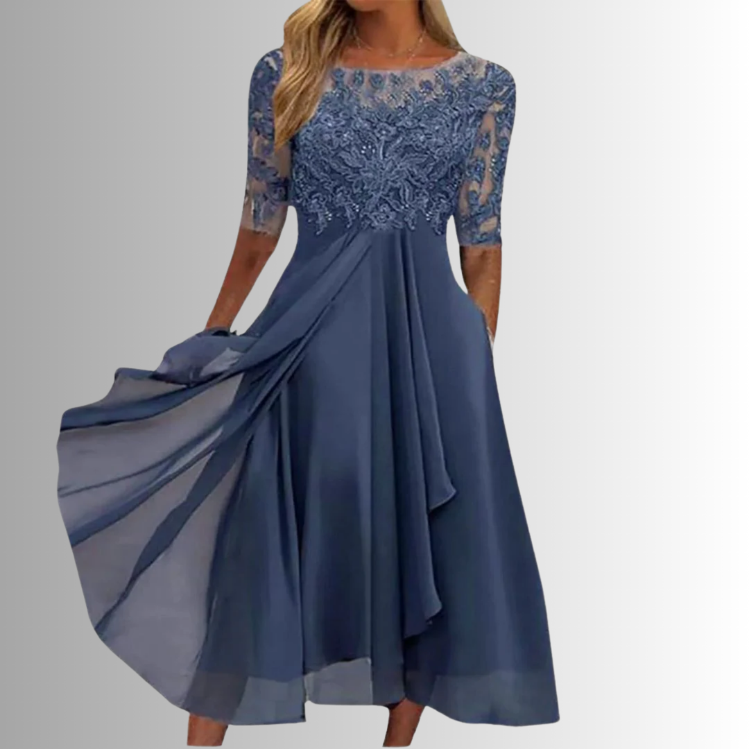 Elegant blue lace dress with sheer sleeves in a studio setting.