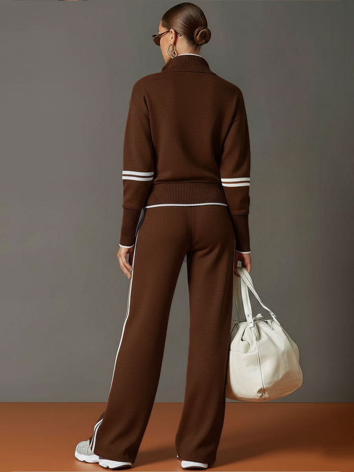 Back view of matching lounge set in brown with contrast stripes, paired with white sneakers and a bag in a studio setting.