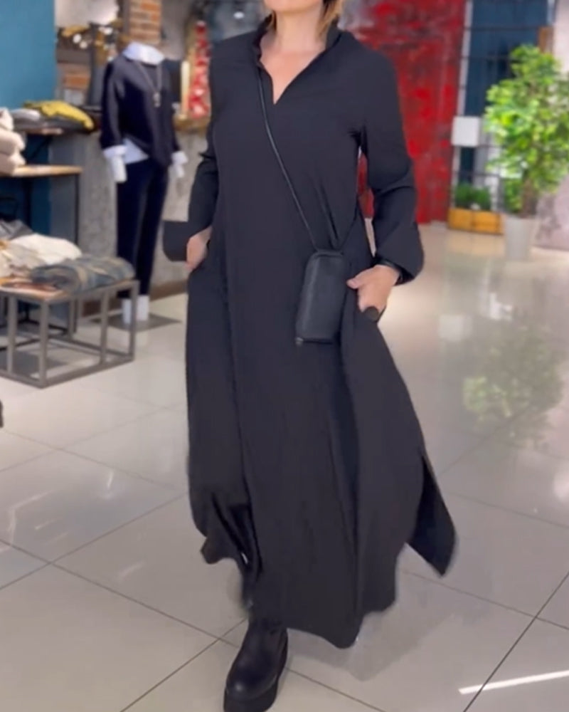 Long black dress with a crossbody bag, worn by a person in a well-lit boutique setting with racks and decor.