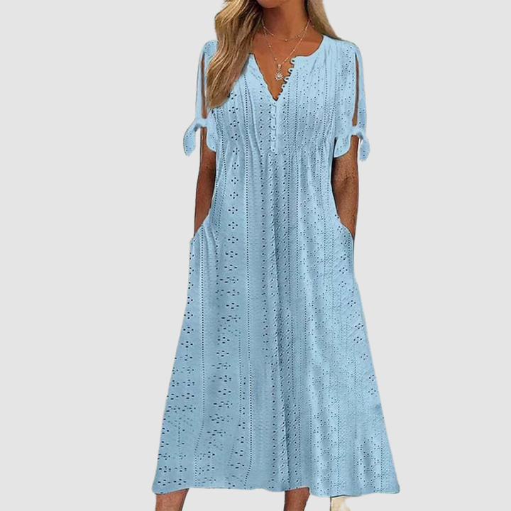 Light blue elegant casual dress with eyelet pattern and tie sleeves, showcased in a studio environment.