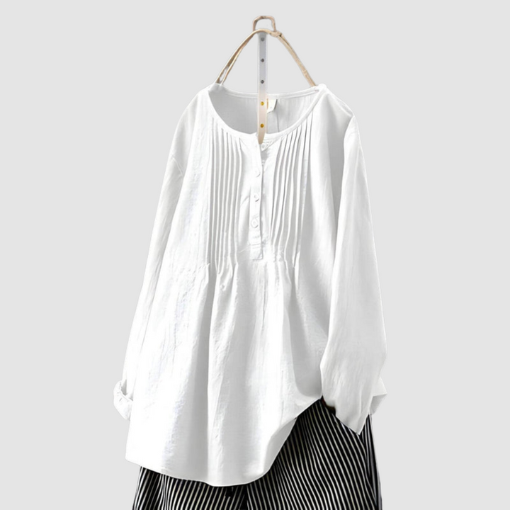 Sophisticated white blouse with pleated front and buttons, displayed on a hanger against a plain background.