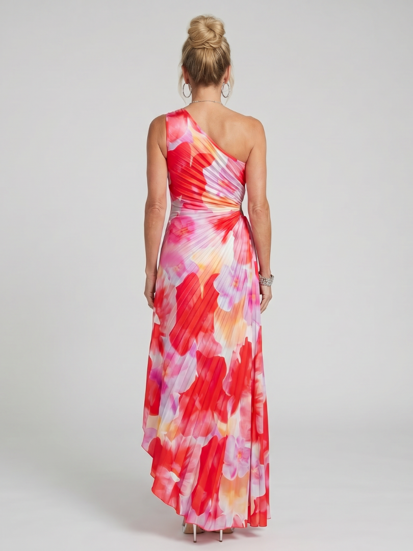 Back view of red floral one-shoulder pleated midi dress in studio setting.