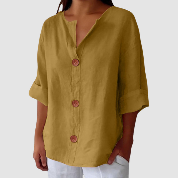 Mustard casual blouse with button-front design, half sleeves, against a plain background.