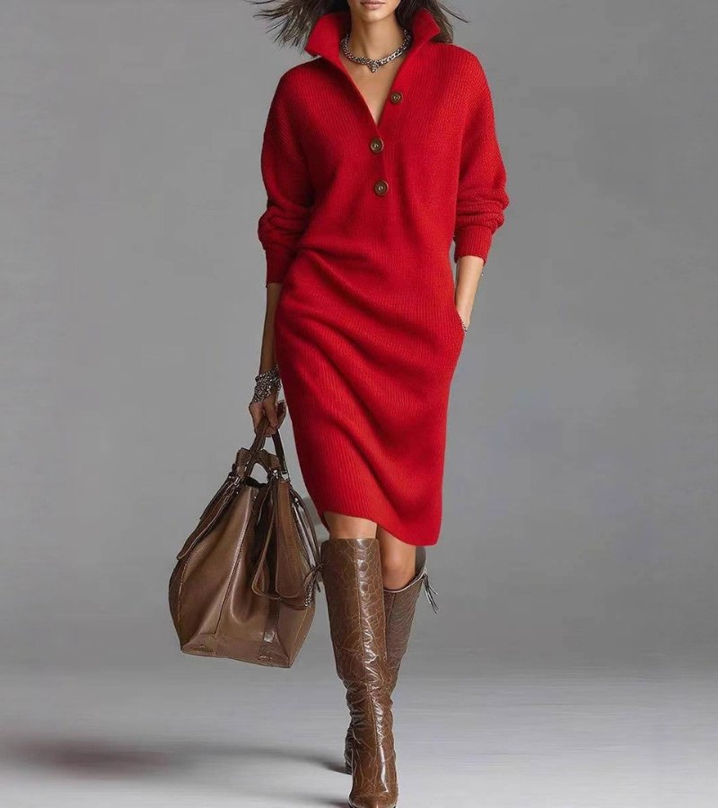 Model in a chic red knit dress with buttons, holding a brown bag. Studio setting with a gray background.
