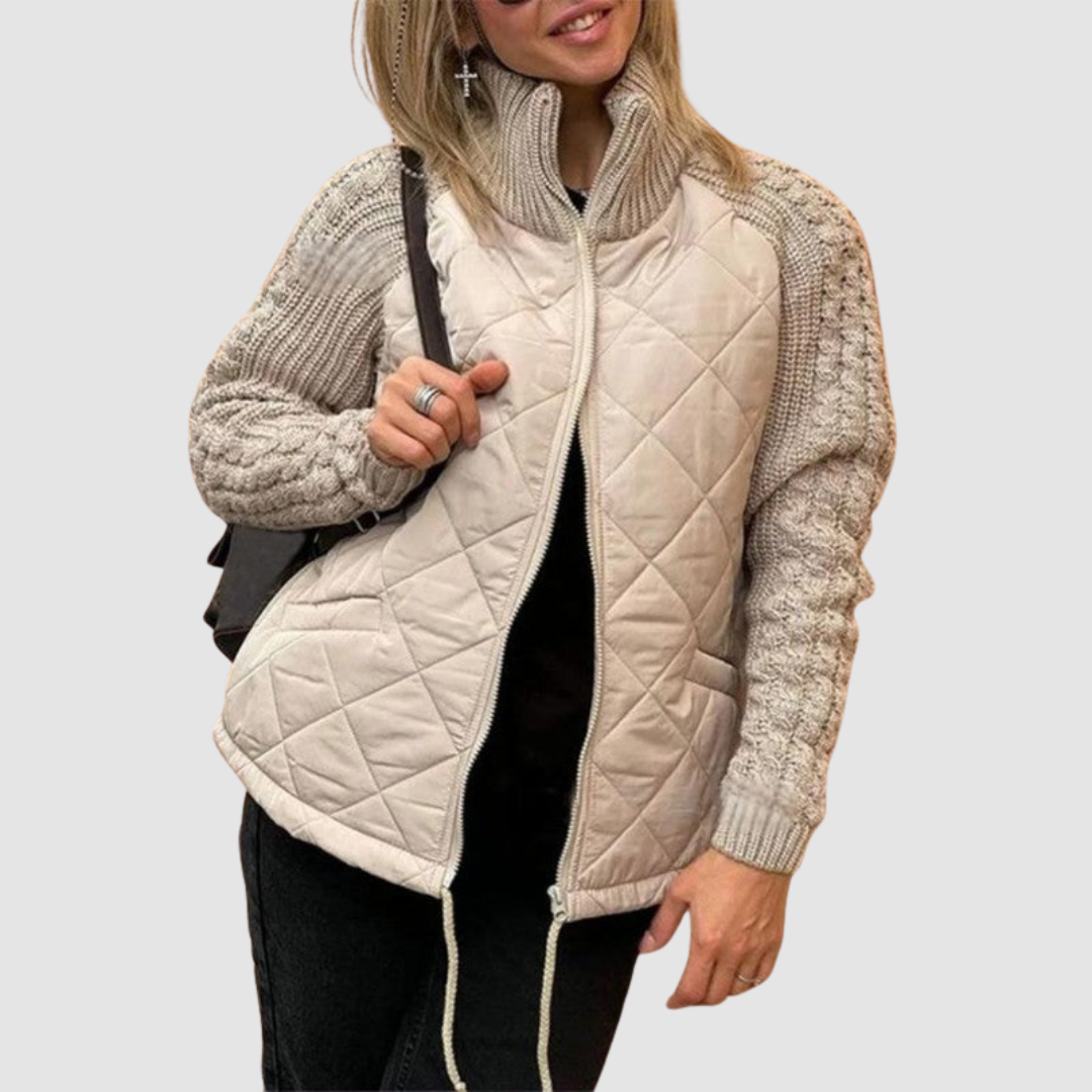 Beige quilted jacket with knit sleeves, worn by a person in casual setting.