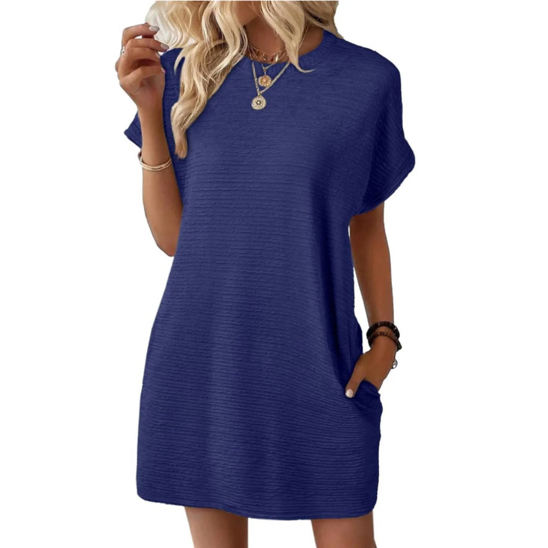 Deep navy blue casual dress with a relaxed fit and short sleeves, accessorized with necklaces in a studio setting.