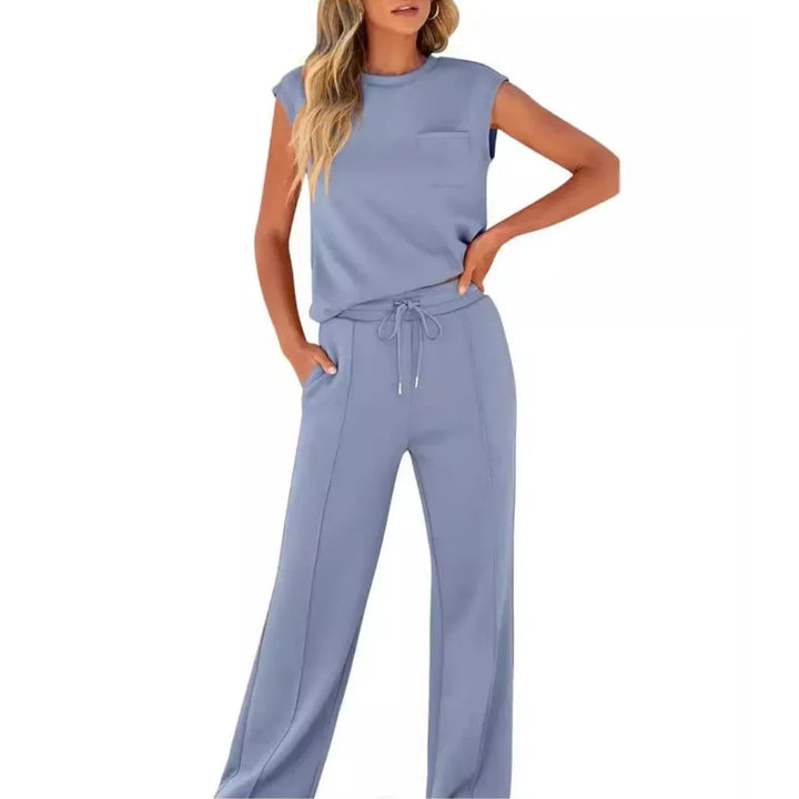 Light blue casual lounge set with sleeveless top and drawstring pants, studio setting.