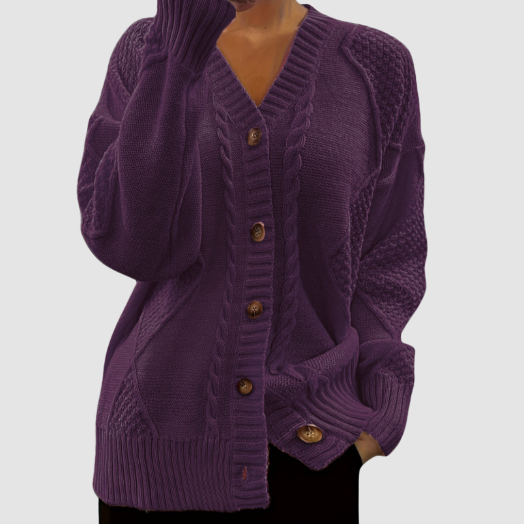 Deep purple button-up sweater with textured patterns, worn by a model; studio background.