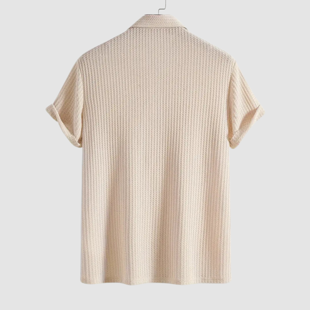 Back view of light cream textured polo shirt on a hanger against a plain light gray background.