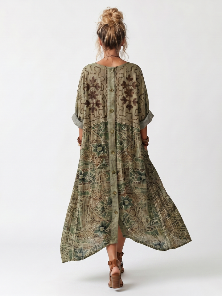 Back view of Aleta midi dress showcasing floral patterns and buttons, worn in a studio setting.