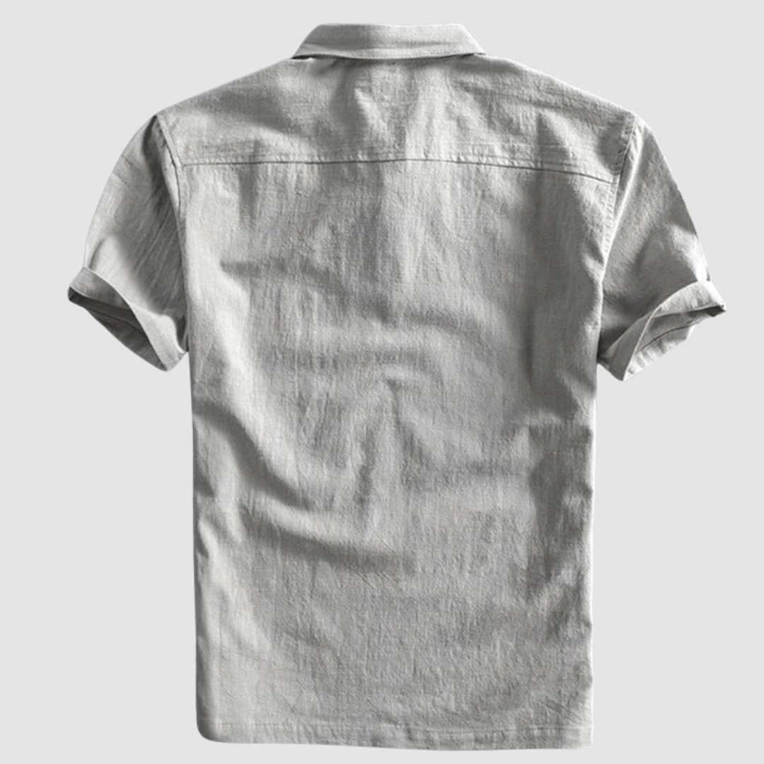 Back view of light gray short-sleeve polo shirt, displayed on a minimalist light gray background.