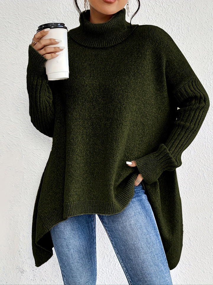 Green turtleneck sweater with long sleeves, holding a coffee cup, paired with jeans against a white background.