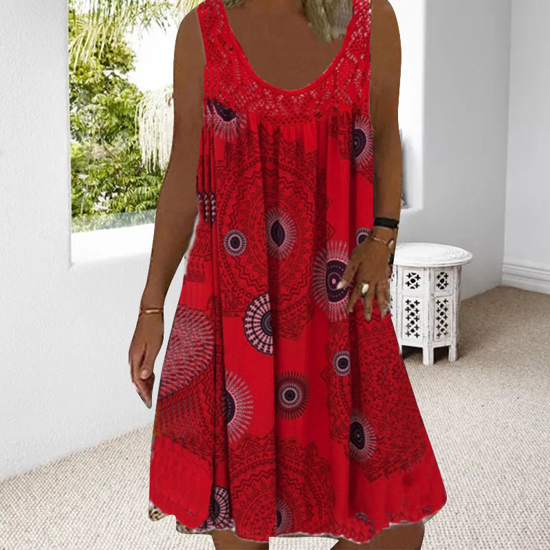 Woman in red printed dress in a bright room with white furniture.