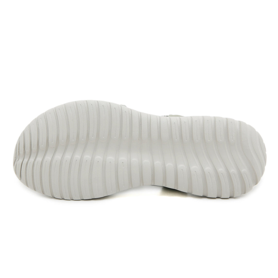 White ridged sole of an orthopedic sandal, displayed in a studio setting.
