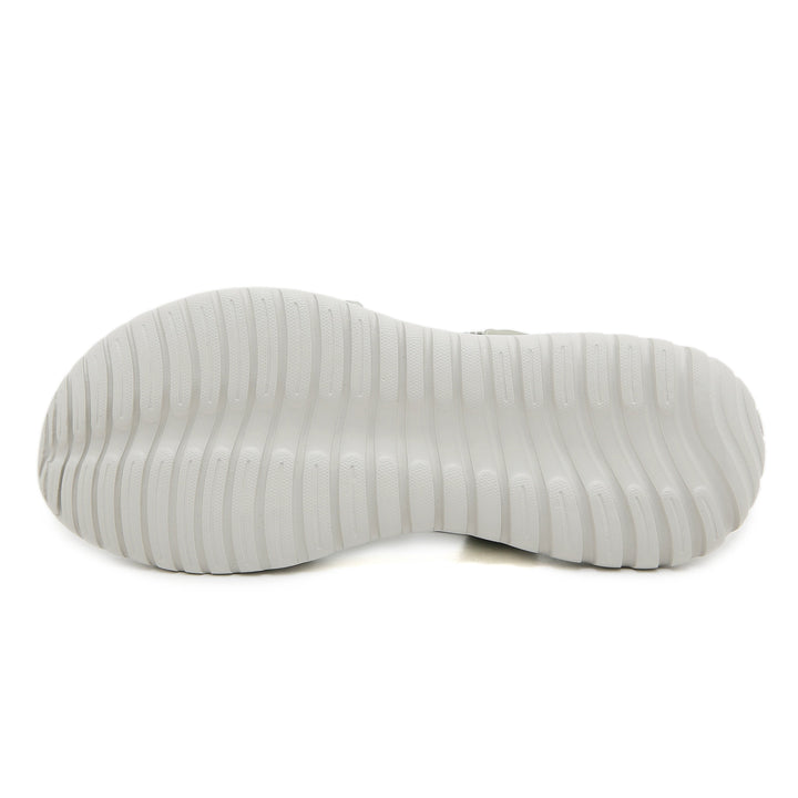 White ridged sole of an orthopedic sandal, displayed in a studio setting.