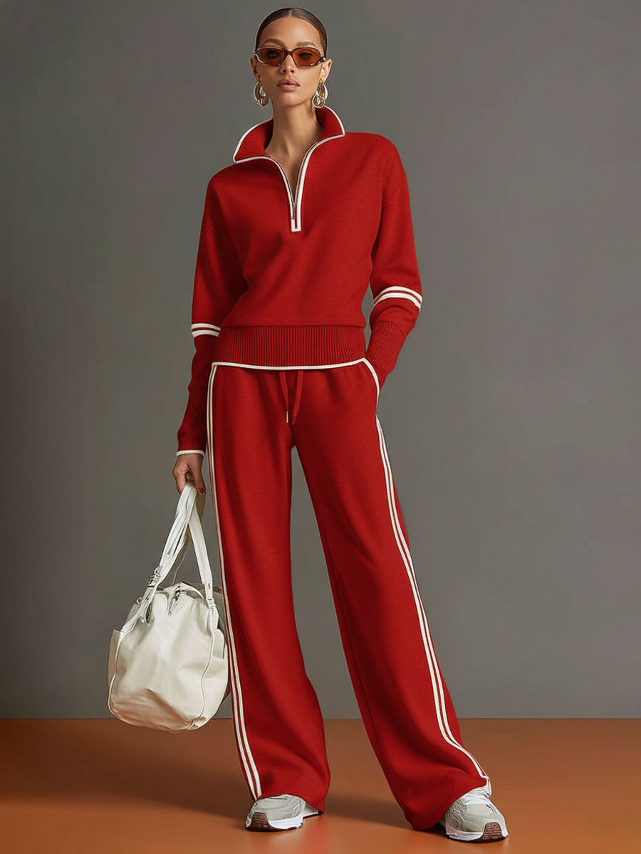 Effortless matching lounge set in red with contrast stripes, styled with white sneakers and a bag in a studio setting.