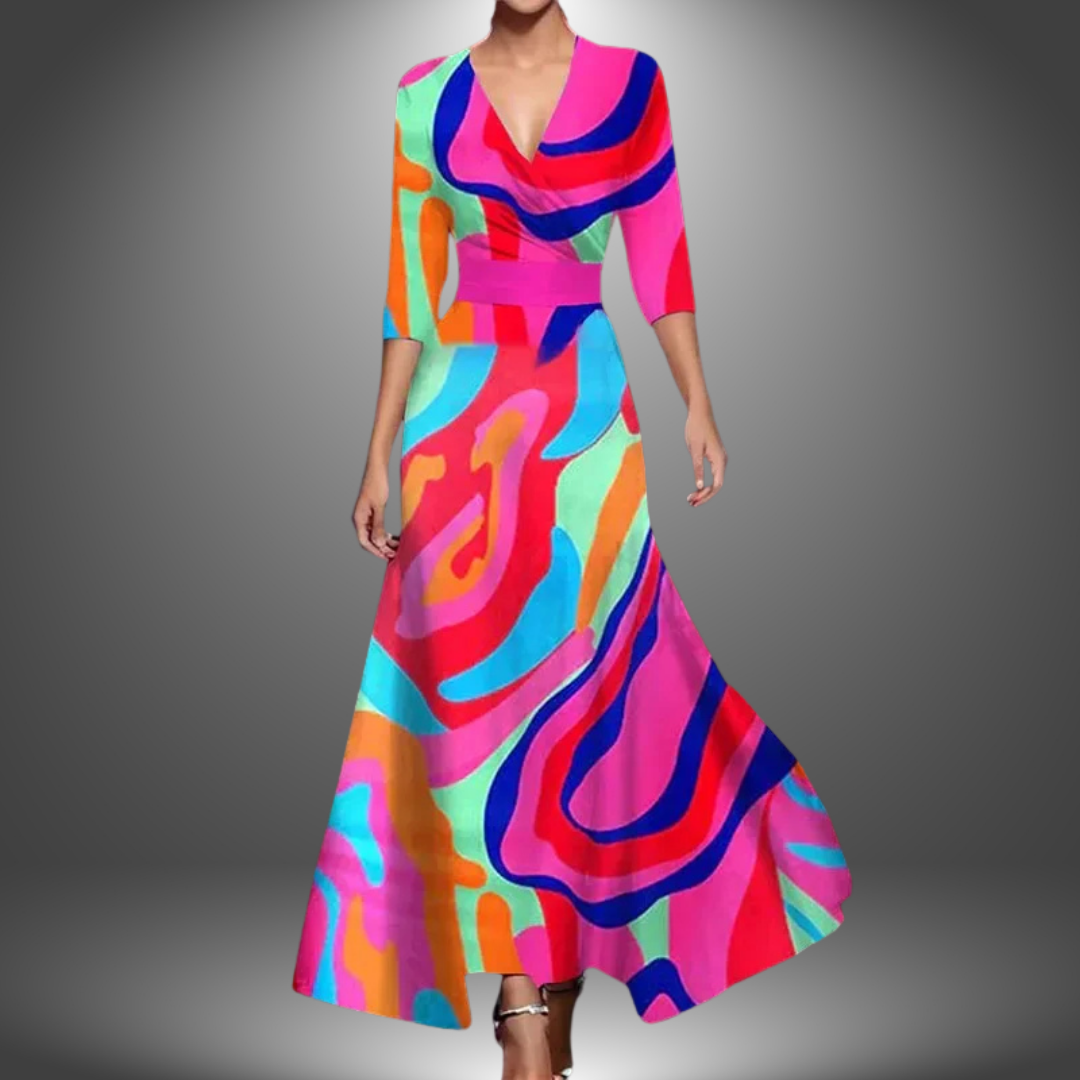 Woman in a long, flowing dress with bold, multicolored abstract pattern, set against a soft gradient studio background.