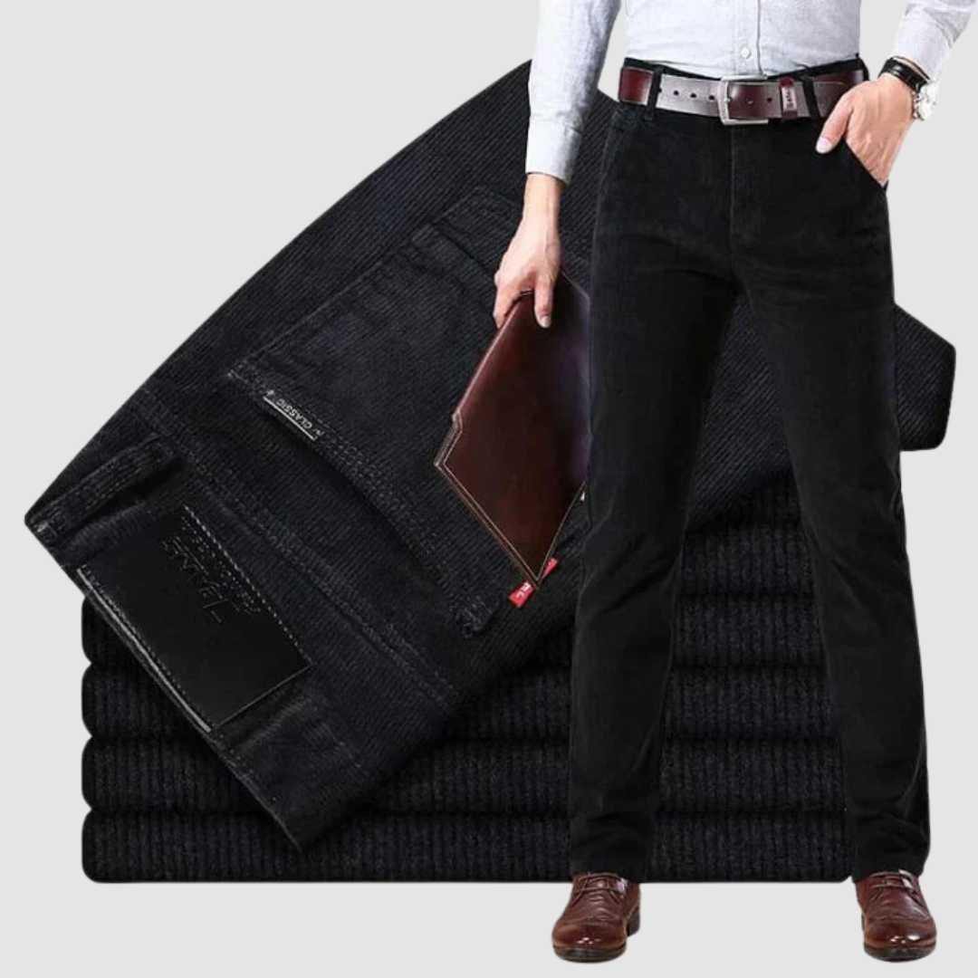 Black corduroy trousers shown in a clean backdrop, focusing on the sleek style and fine texture.