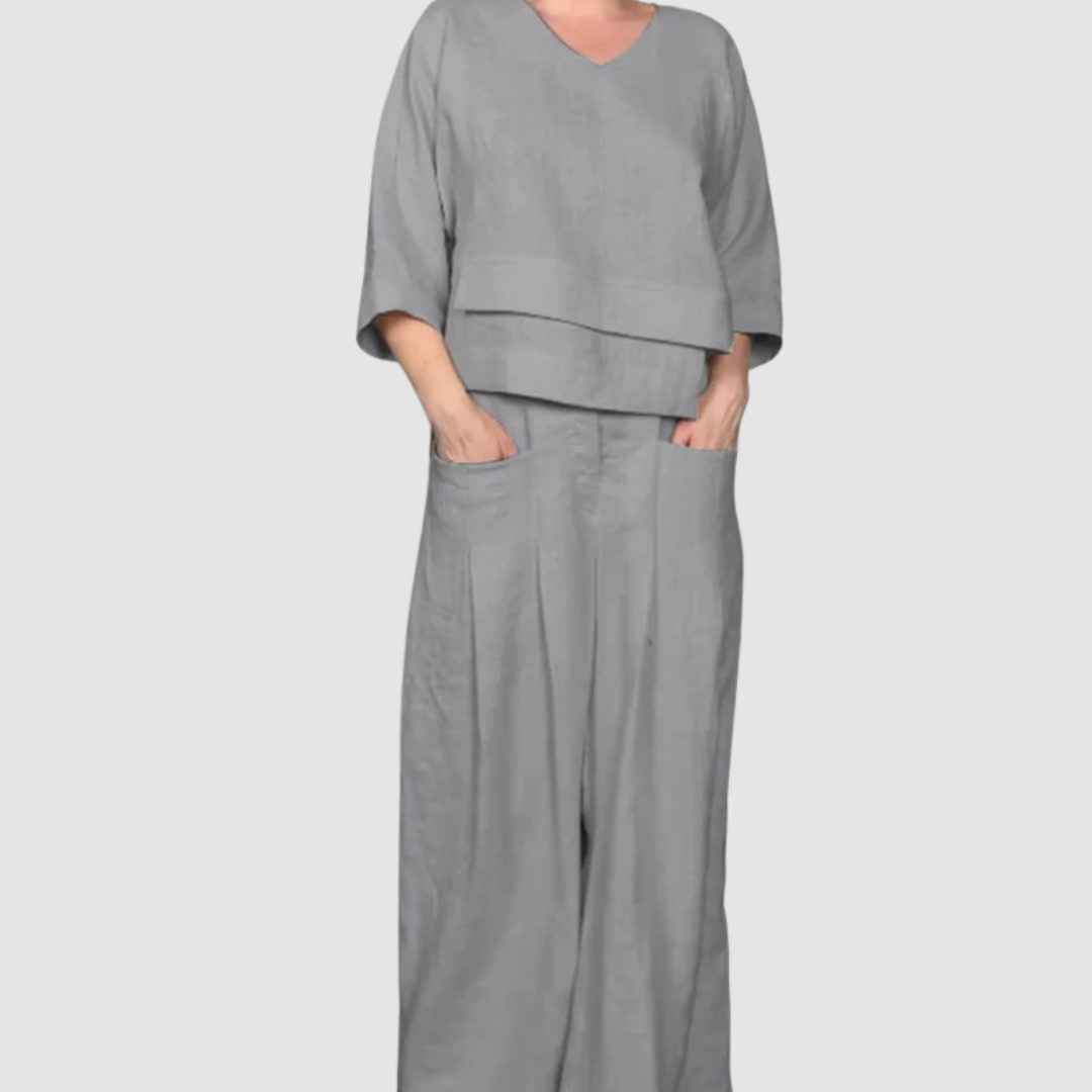 Gray relaxed 2-piece set with V-neck top and wide-leg pants featuring pockets, studio background.