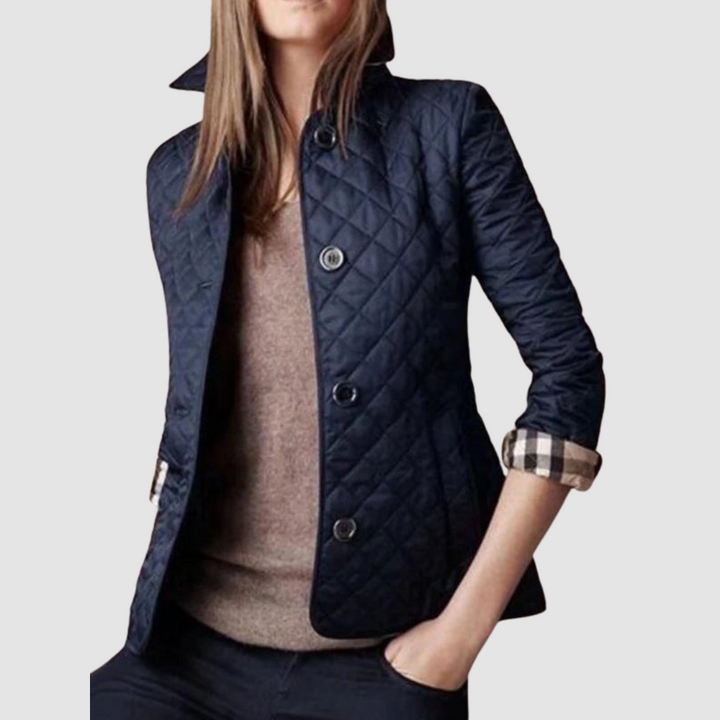 Navy quilted jacket with buttons, styled with brown top and black pants on a model, light background.