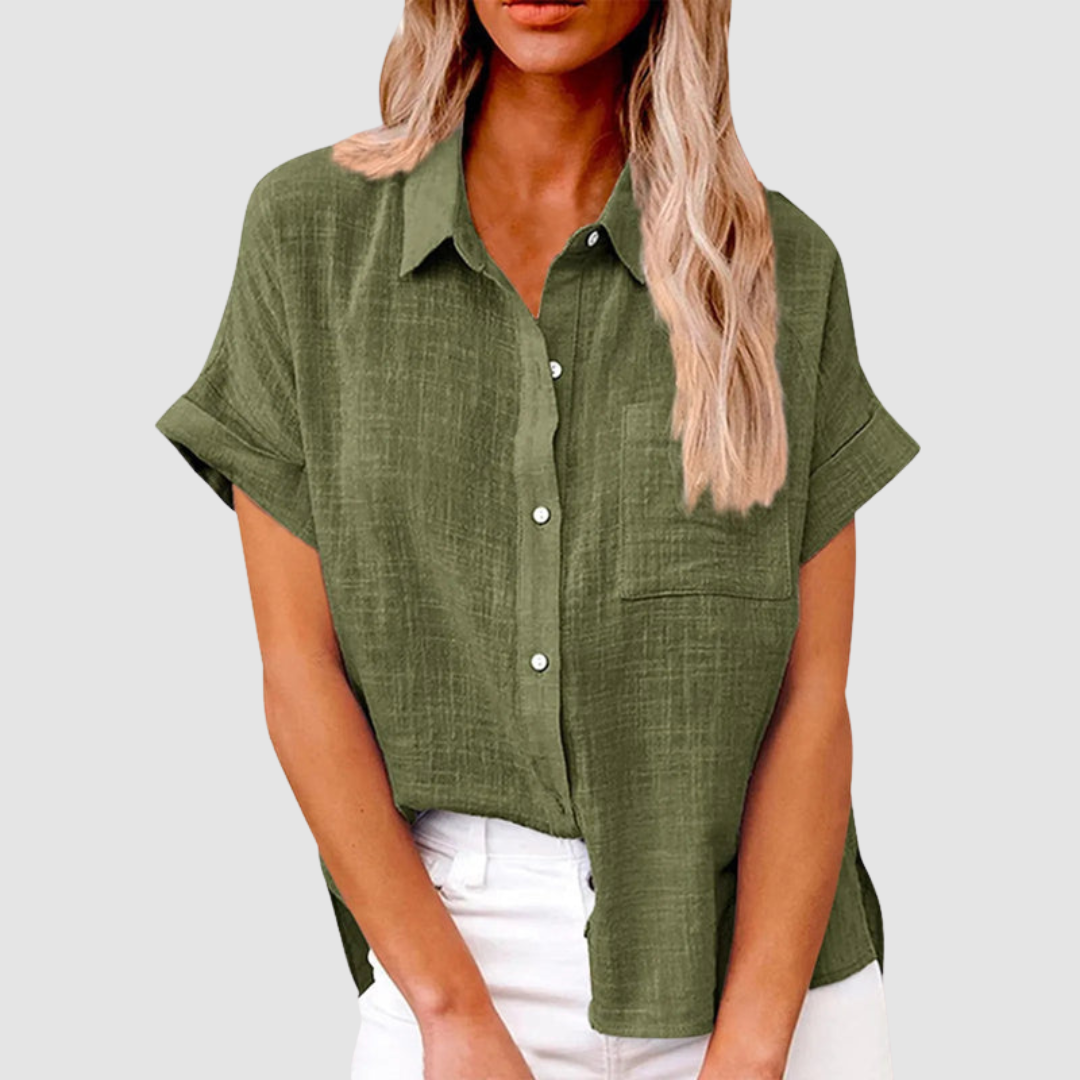 Olive green casual blouse with short sleeves and front buttons, worn in white jeans. Studio background.