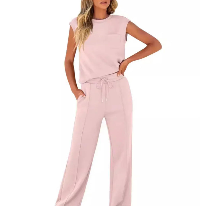 Light pink casual lounge set featuring sleeveless top and drawstring pants, studio setting.