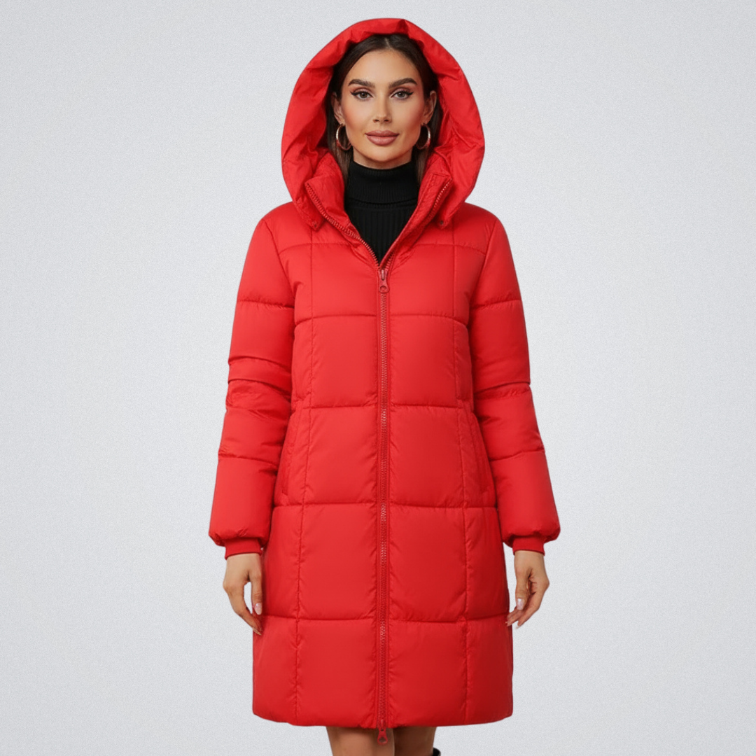 Woman wearing a vibrant red puffer coat with hood, standing against a plain white background.