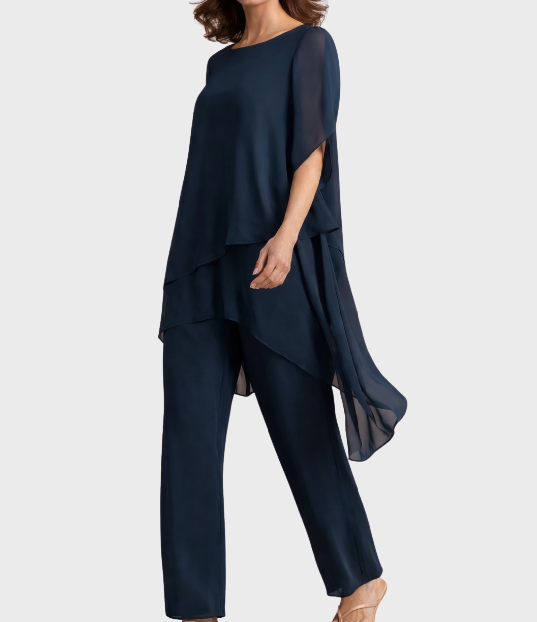 Navy two-piece outfit with an asymmetrical hemline, model side view in studio setting.