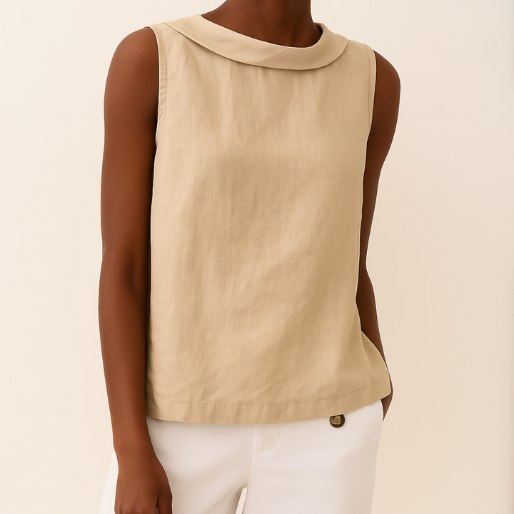 Beige sleeveless top with roll collar on model, styled with white pants, set against a light background.