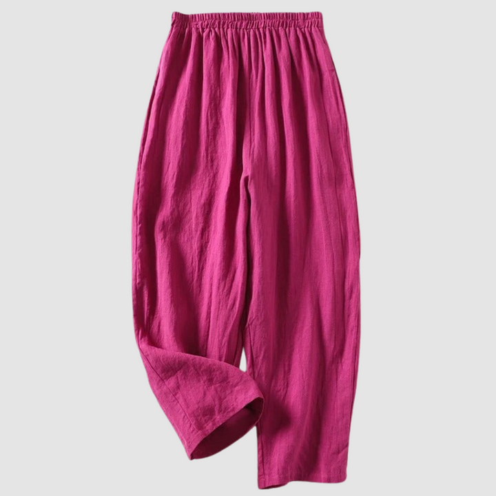 Pink relaxed-fit pants with elastic waistband, styled on a light gray background.