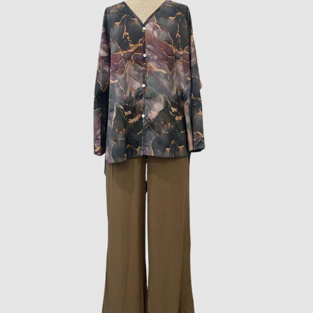 Mannequin showcasing elegant printed two-piece set with a button-up top and wide-leg pants, in a studio setting.