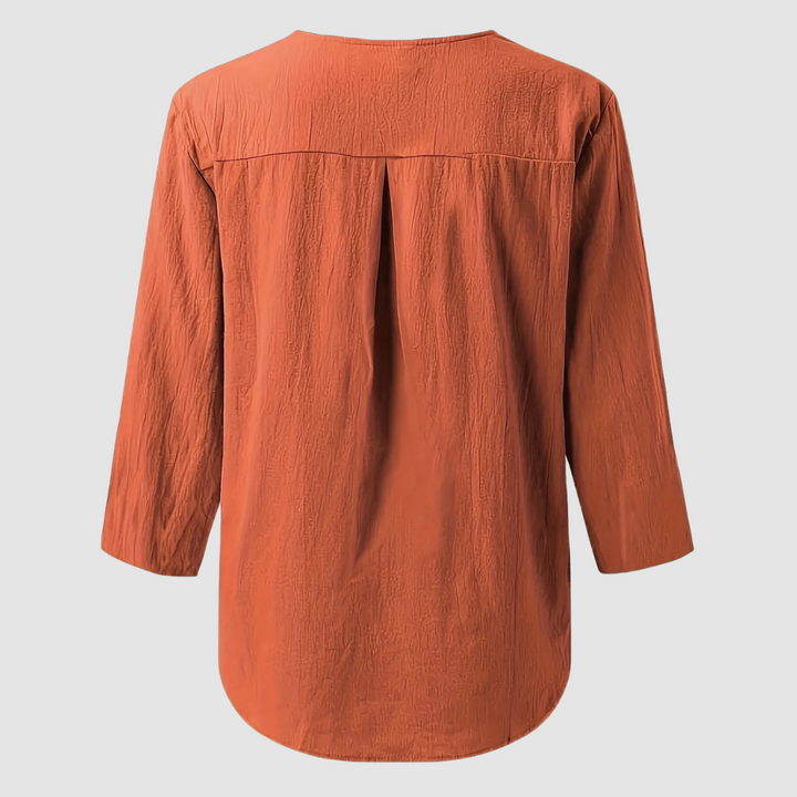 Back view of a rust casual blouse displayed flat against a plain background.