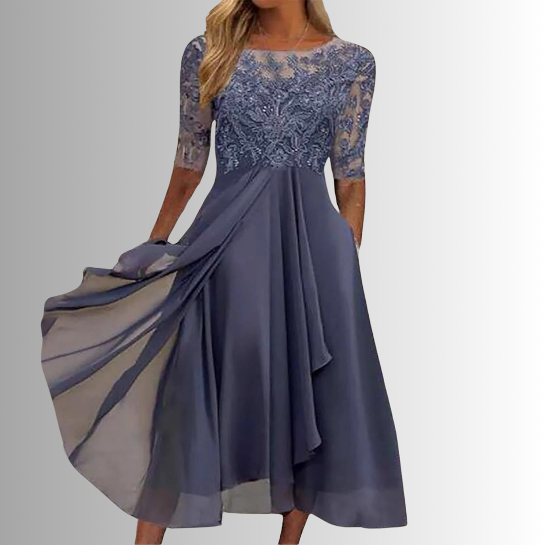 Elegant blue lace dress with sheer sleeves in a studio setting.
