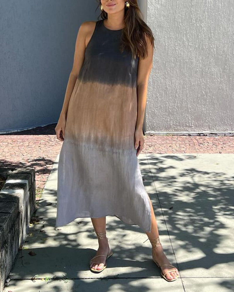Model wearing an ombre black to brown sleeveless dress in a sunny outdoor setting.