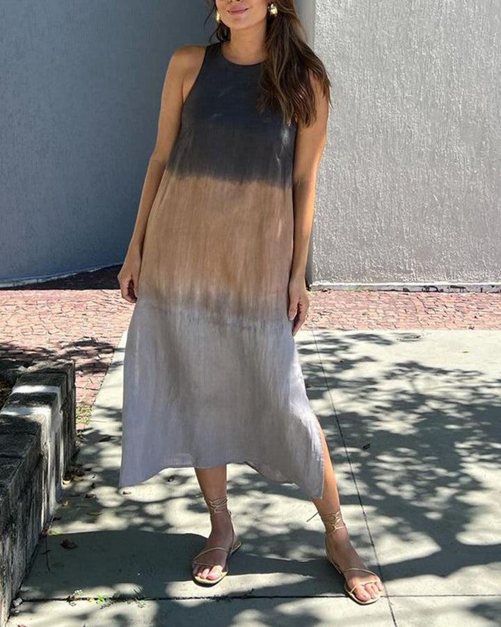 Model wearing an ombre black to brown sleeveless dress in a sunny outdoor setting.