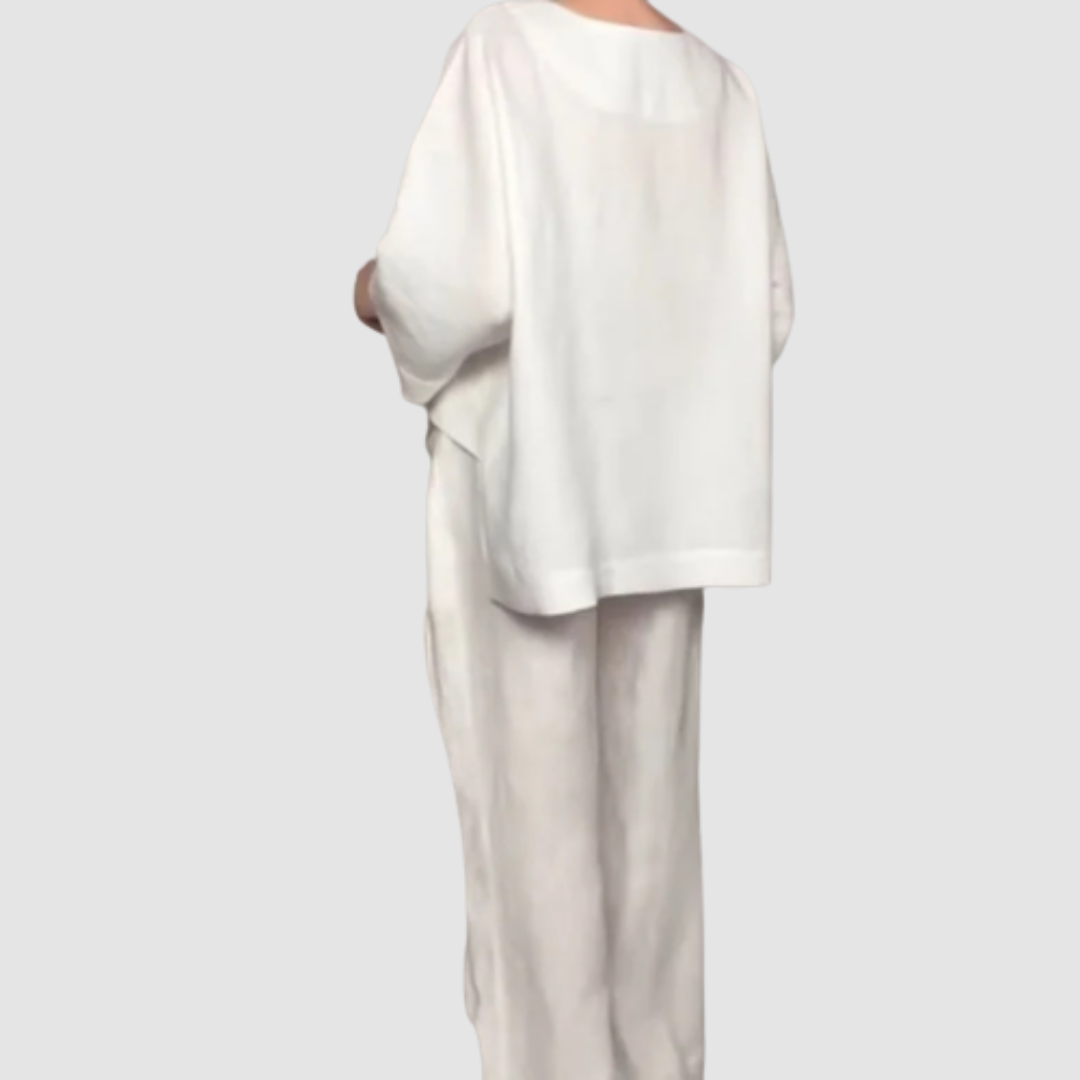 Back view of white relaxed 2-piece set with loose top and wide-leg pants, studio background.