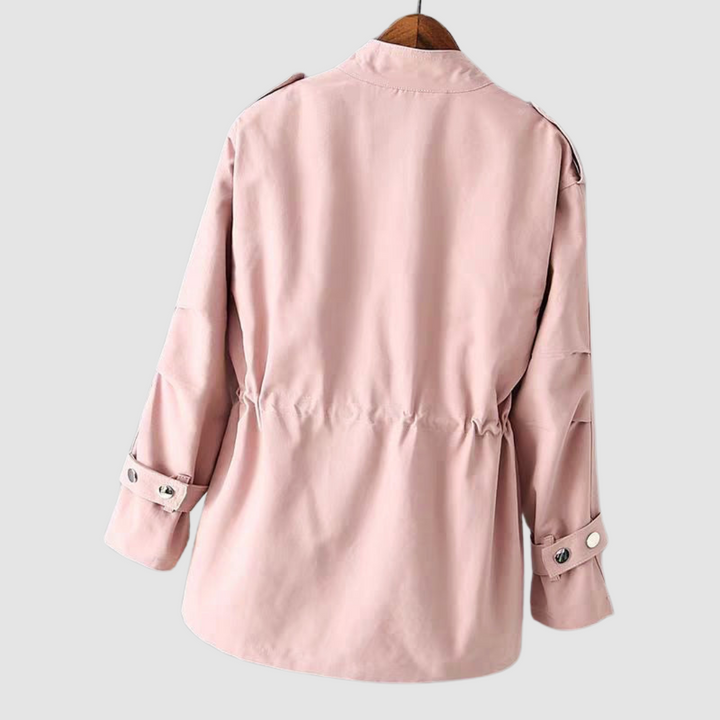 Back view of a light pink jacket with cinched waist and button details on cuffs, hanging on a white background.