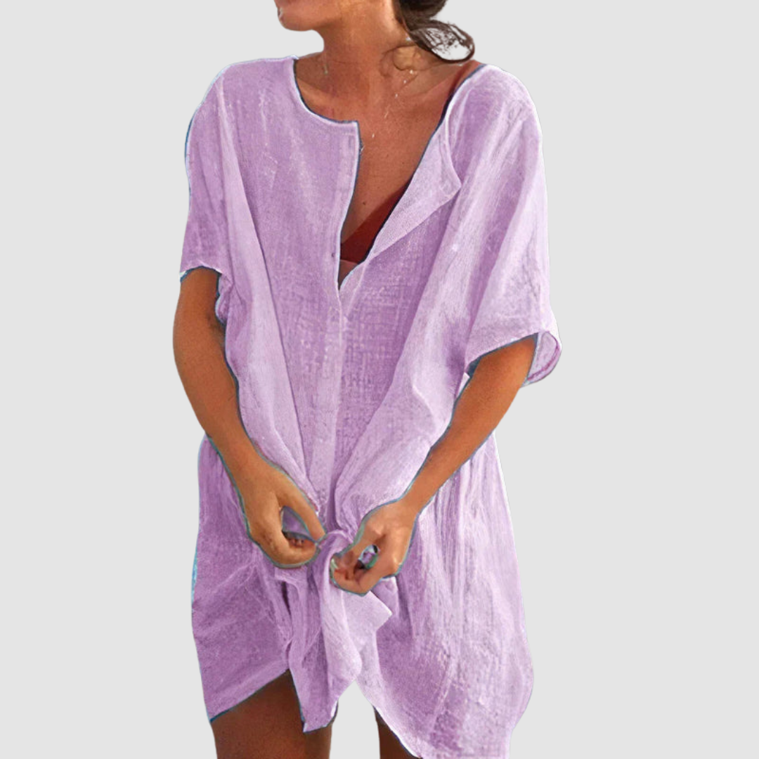 Purple loose fit dress with short sleeves and textured fabric, worn by person with untied front, studio background.