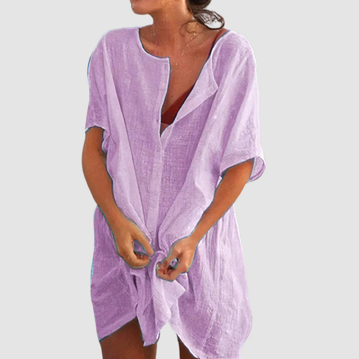 Purple loose fit dress with short sleeves and textured fabric, worn by person with untied front, studio background.