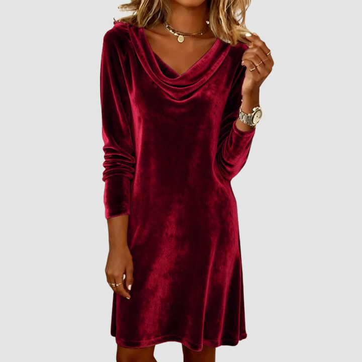 Red velvet long sleeve dress with a draped neckline on a white background.