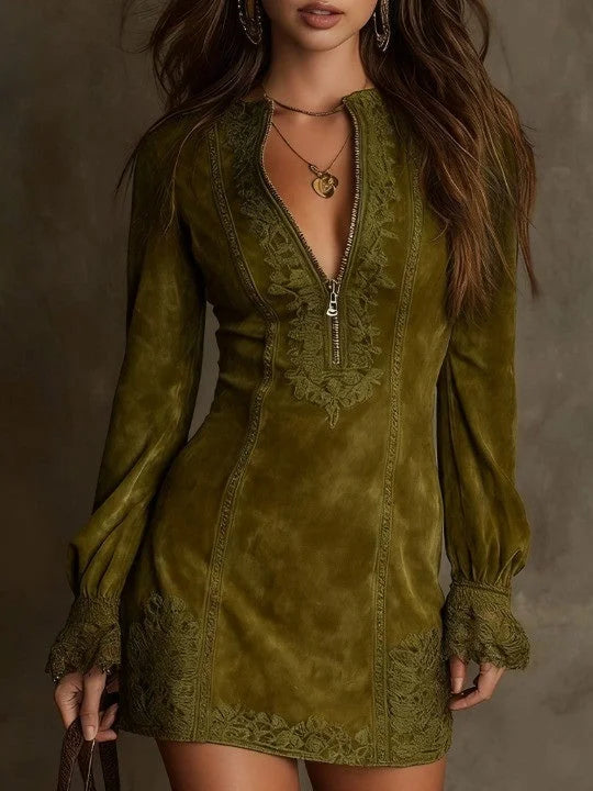 Green suede mini dress featuring lace details, long sleeves, and a zipper front in a studio setting.
