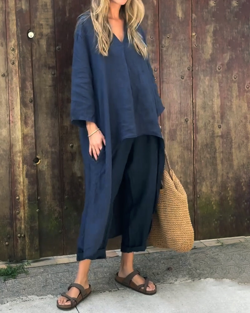 Navy set styled with woven bag and sandals against wooden wall.