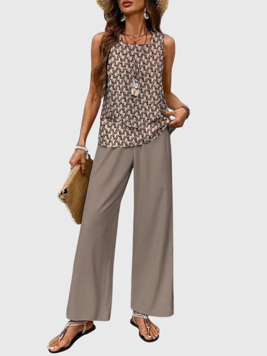 Model in patterned sleeveless top and solid wide-leg pants. Neutral backdrop.