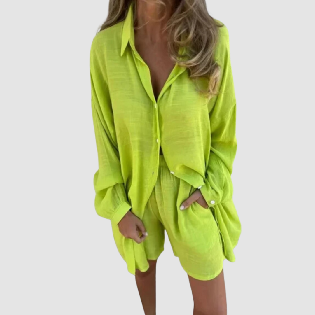 Model wearing a lime green two-piece set with button-up shirt and shorts; neutral studio background.