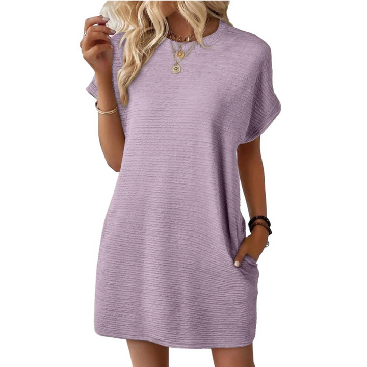 Soft lavender casual dress with a loose fit and short sleeves, worn with necklaces and bracelets in a studio.
